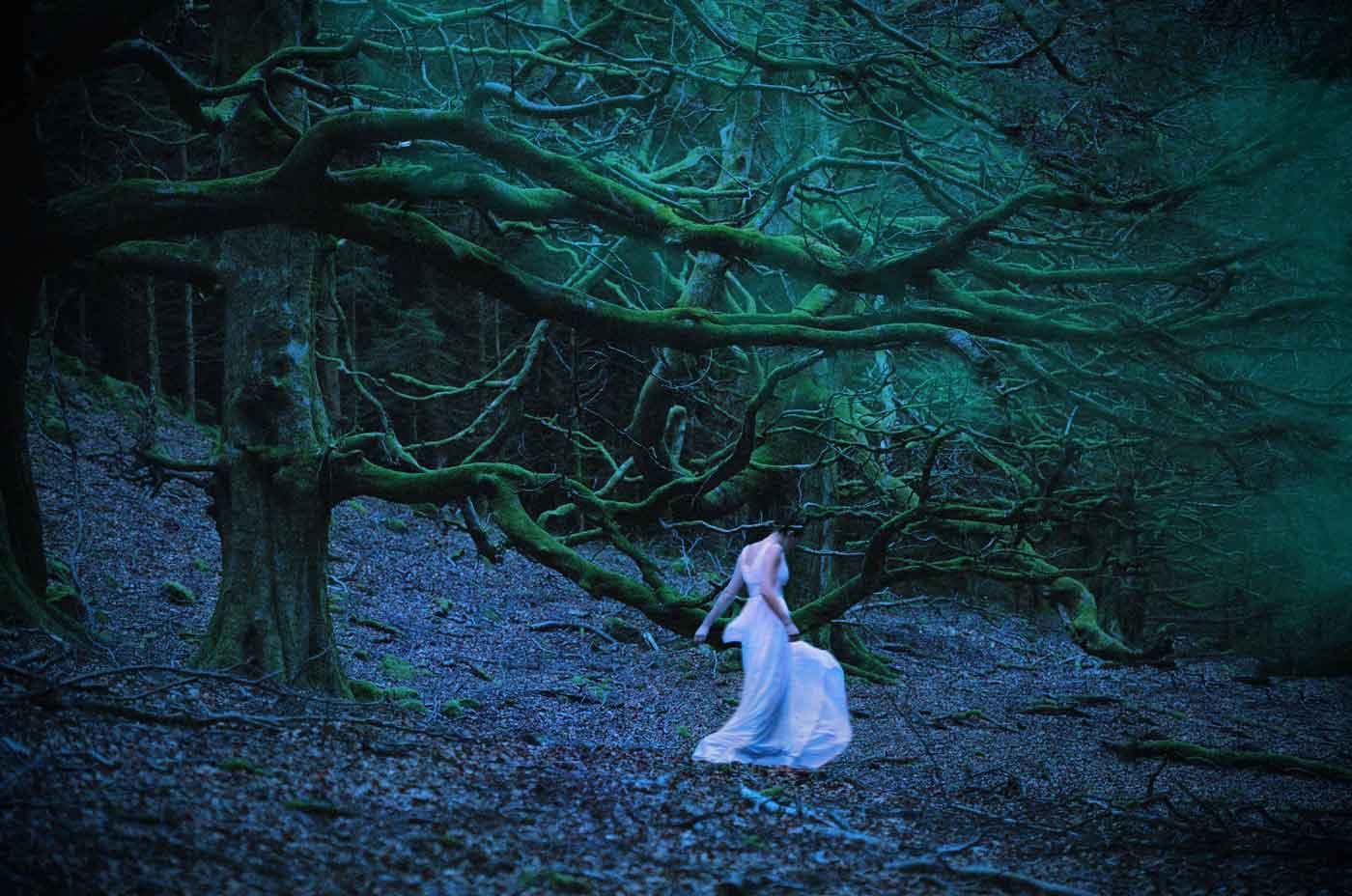 Fashion Photography: ethereal female in flowing dress, forest setting